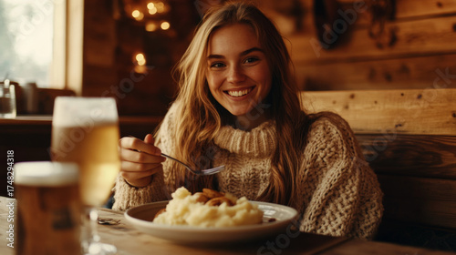 Smiling Woman Enjoying Comfort Food and Beer at Cozy Restaurant