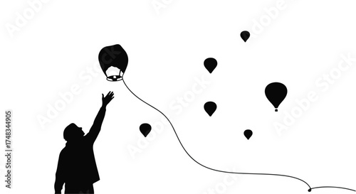 Silhouette of a person reaching for a floating lantern against a sky filled with other lanterns