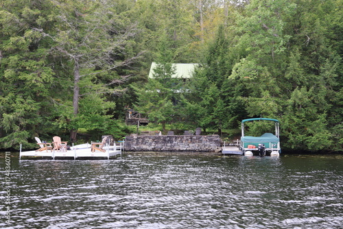 Obraz na plátně A large lake front mansion with a silver-colored metal plating on the outside