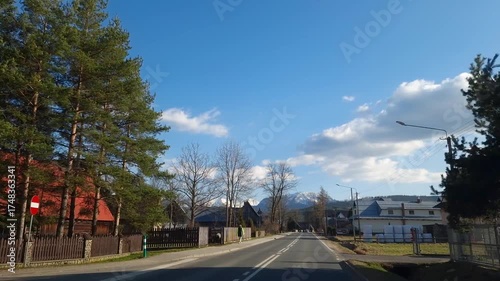 04 03 2025: Beautiful view of Tatra Mountains. driving car through village Witow Poland