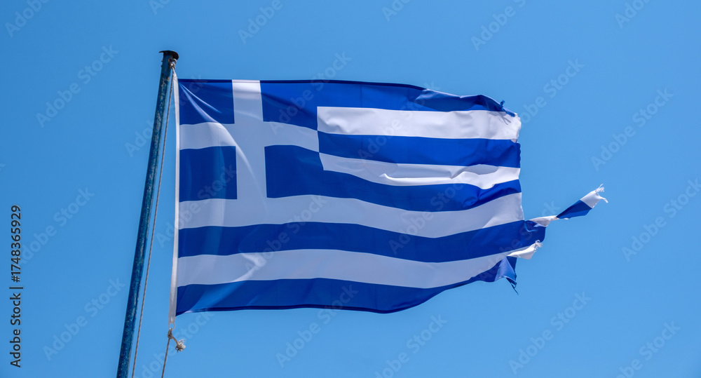 Obraz premium Greece sign symbol. Greek national flag on flagpole waving in the wind, blue sky