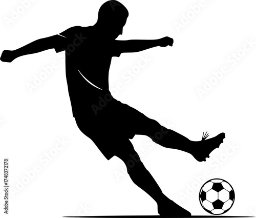 Silhouette of soccer player kicking ball
