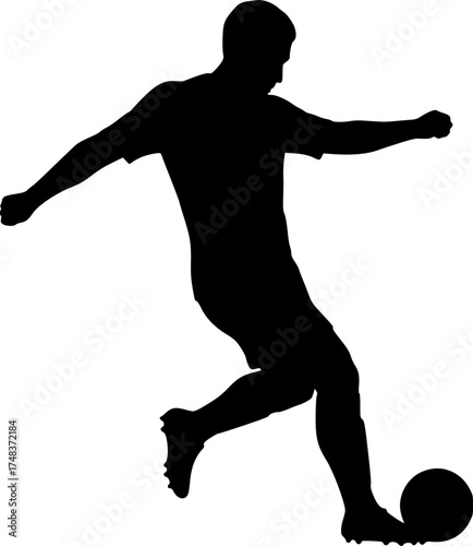 Silhouette of soccer player kicking ball
