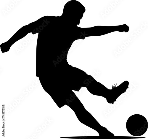 Silhouette of soccer player kicking ball
