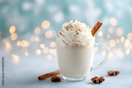 beautifully presented glass mug filled with a creamy, frothy beverage, garnished with a cinnamon stick and whipped cream,  A warming winter drink.