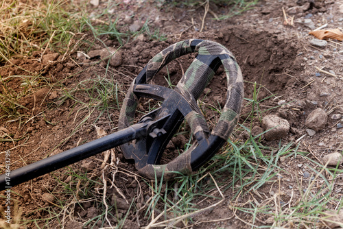 A metal detector for archaeological prospecting, photographed close-up, outdoors.