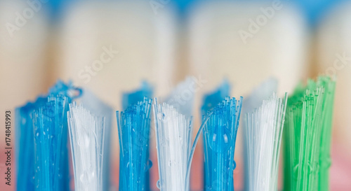 Extreme closeup macro shot toothbrush bristles, showing the texture and colors blue, , and green bristles, highlighting dental hygiene and oral care