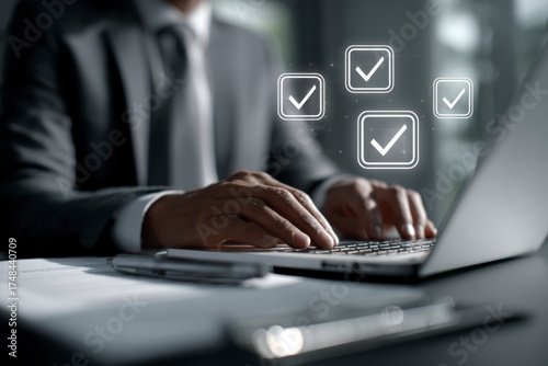 Professional Completes Task: Close-up of a person in a suit using a laptop with checkmark illustrations.