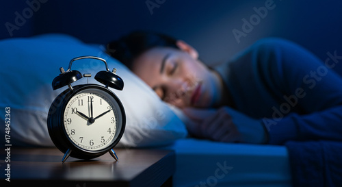 Man peacefully sleeping next to alarm clock in dimly lit bedroom, concept of Daylight Saving Time Change  