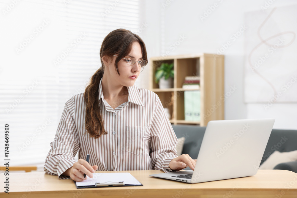 Fototapeta premium Professional psychotherapist working on laptop at table in office