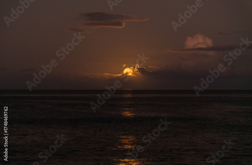 Beautiful full  moon moonset over Pacific ocean on Oahu, Hawaii 