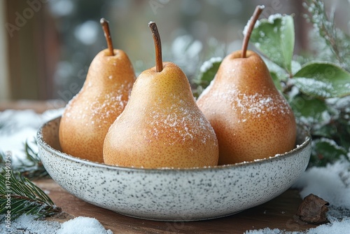 pears in a bowl on a table.