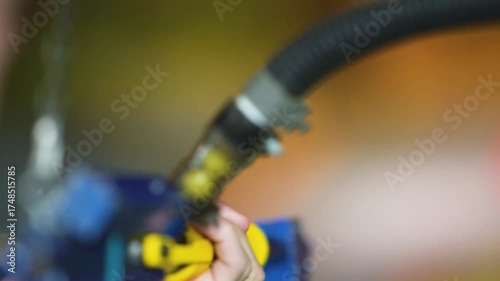Close up of person holding paint spray gun