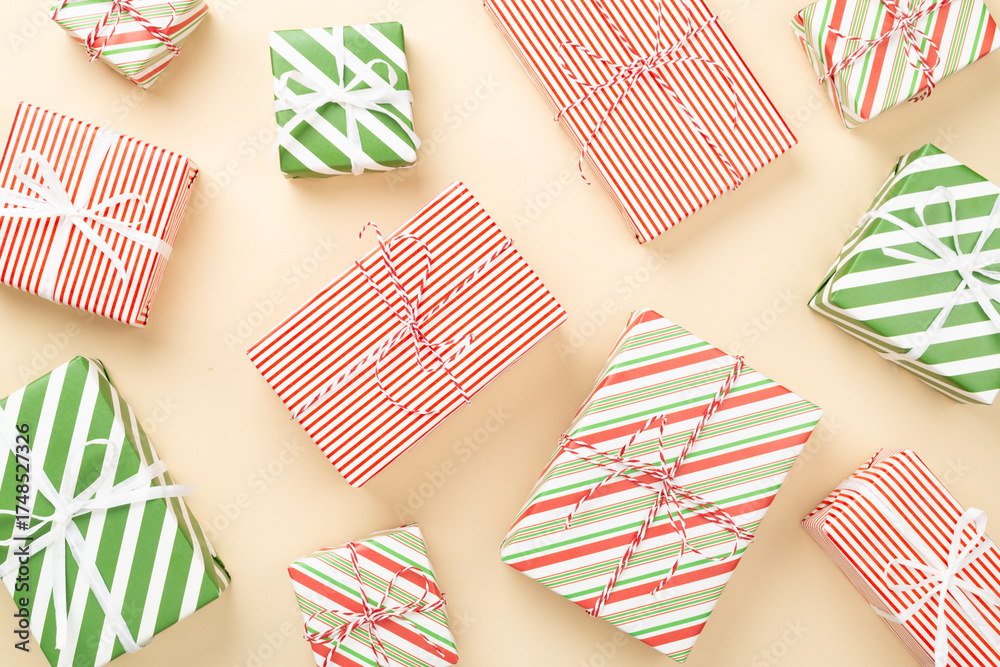 Obraz premium Many striped Christmas gift boxes on color background, top view