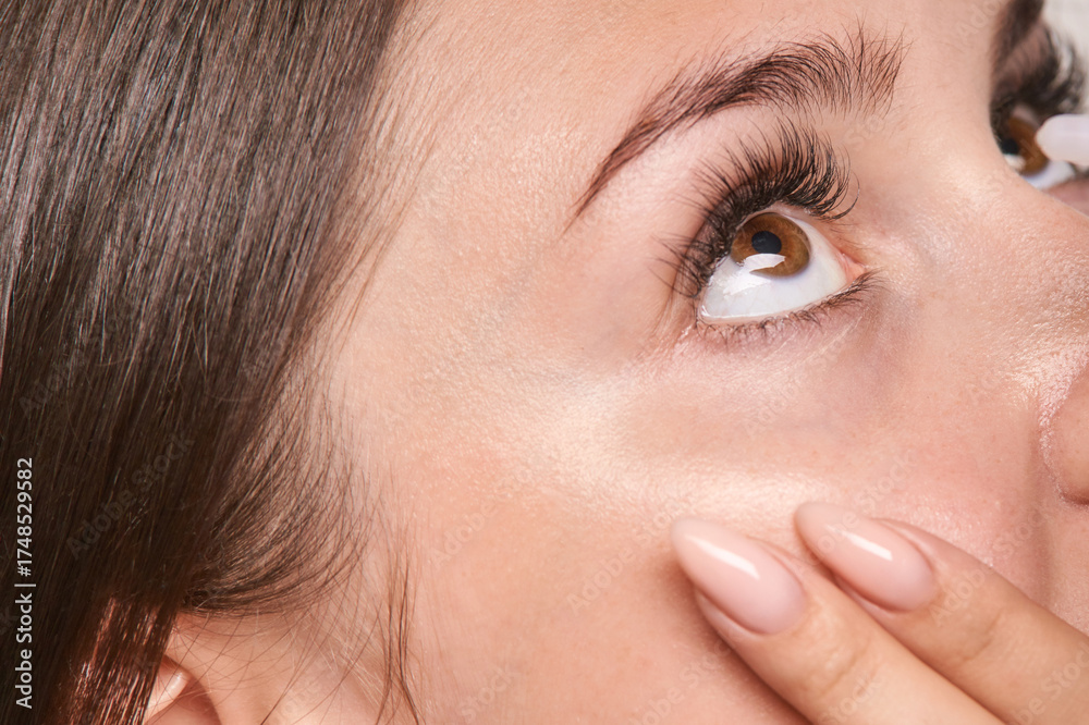 Fototapeta premium Close-up of caucasian female young adult eyes with natural makeup and long eyelashes.
