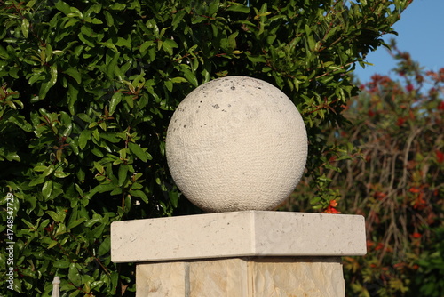 Decorative ball on a stone fence