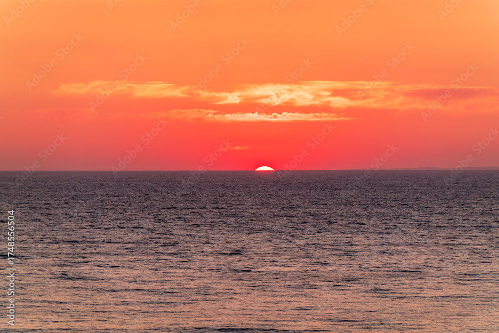 Obraz premium Beautiful red and orange sunrise over the sea.