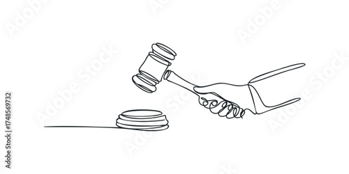 Hand holding a gavel striking a sounding block