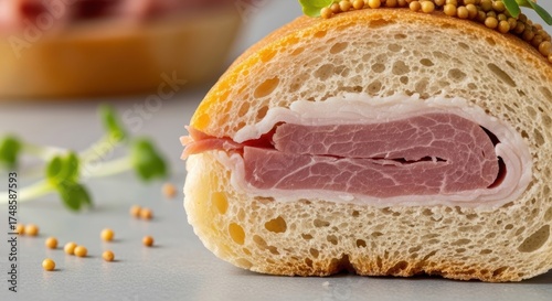 Close-up of ham and mustard in fresh baguette with microgreens garnish