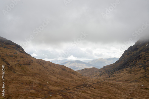 Obraz na plátně Misty foggy hills mountains in Scotland dramatic landscape hiking tourism active