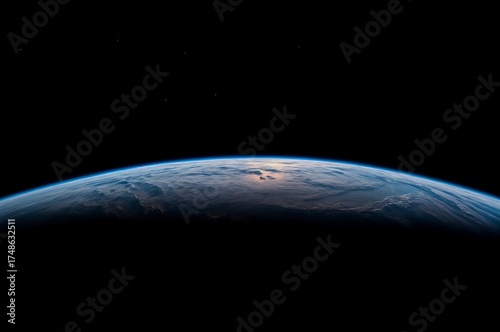 View of Earth from space showing curvature and atmosphere against a dark background during the daytime