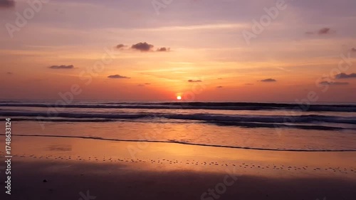 Serene coastal sunset ocean waves reflecting the warm glow of evening