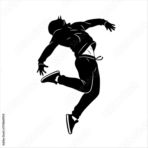 An energetic dancer executing an impressive dance move, captured in silhouette form. His posture exhibits grace and dynamism