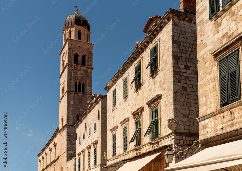 Fototapeta premium Bell tower, stone building, green window shutters