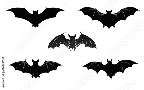 Set of five black flying bat silhouettes for Halloween.