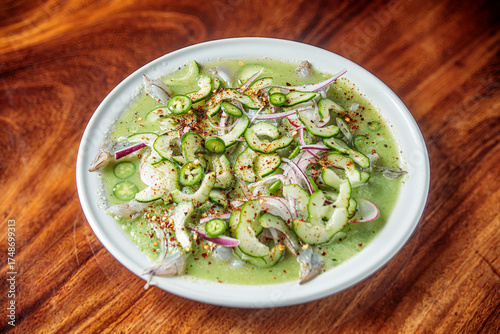 Mexican seafood called aguachile, raw shrimp dipped in lime and green sauce