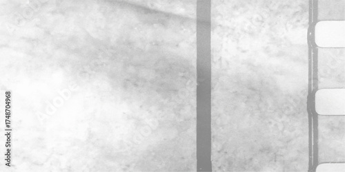 Vintage film projector gate casting a dark gray grunge texture shadow on a white concrete wall