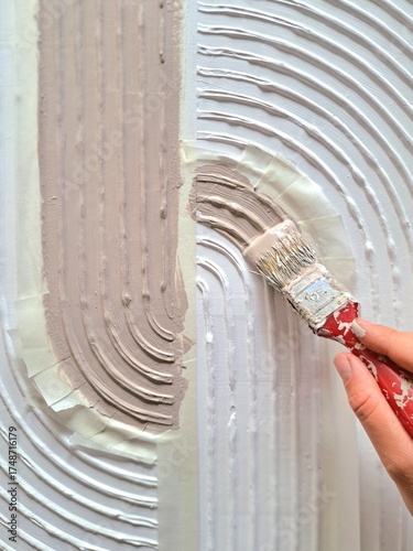 The process of making a painting from structural paste using art tools and paint brush