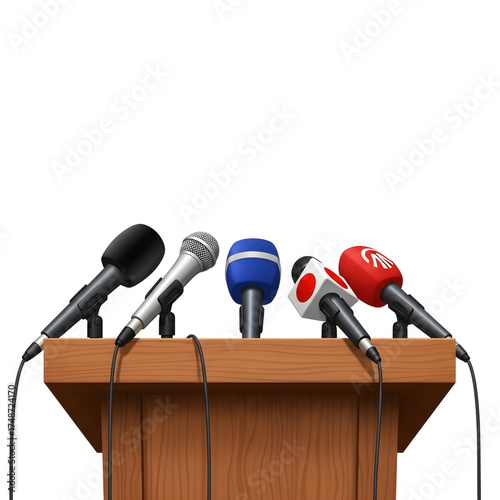 Multiple microphones ready for a press conference on a wooden podium