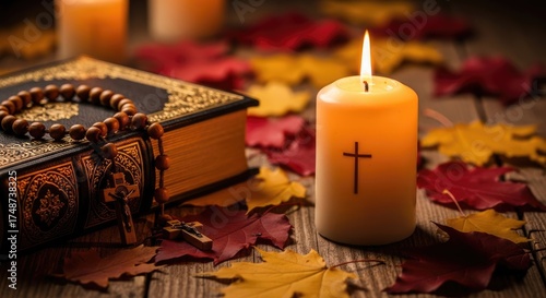 All Saints' Day commemoration with burning candle featuring cross, holy Bible, and rosary on rustic wood, colorful autumn leaves, spiritual devotion scene.