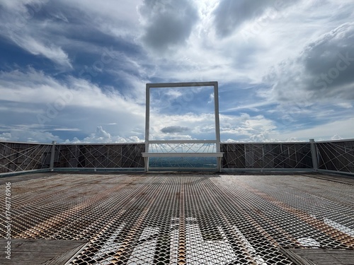 Window frame with cloudy blue sky in background
