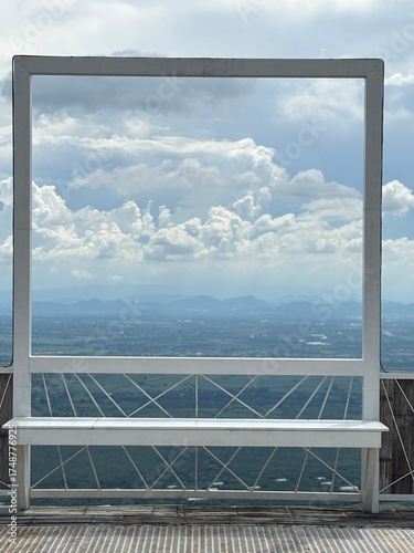 The window frame with cloudy sky in background