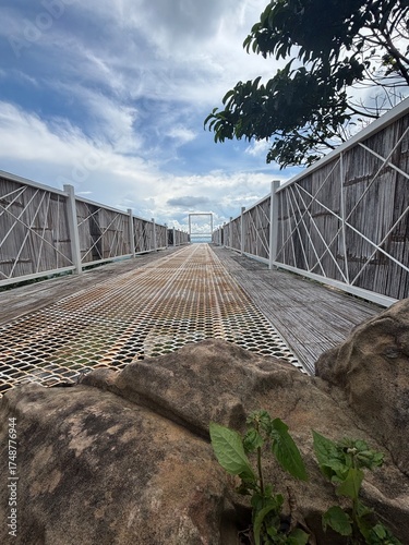 The walkway to window frame with cloudy sky in background