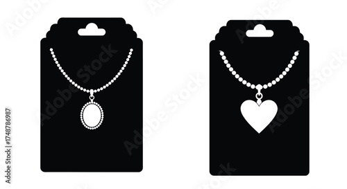 Black jewelry tags displaying delicate necklaces with pendant charms