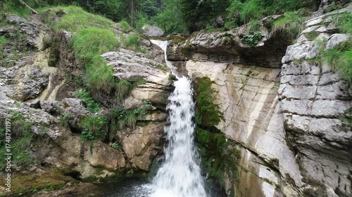 Aerial 2D footage of a rocky alpine stream flowing through a forest valley in Upper Bavaria, Germany. Captures natural textures and calm water motion.
