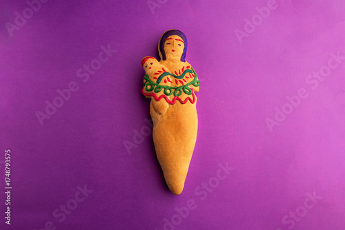 Traditional Ecuadorian Bread Doll with traditional colada morada Drink on Vibrant Background