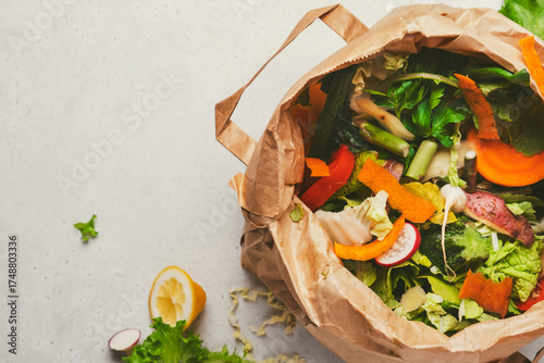 Fresh vegetable peelings and food scraps fill brown paper bag, emphasizing the importance of composting in reducing food waste at home