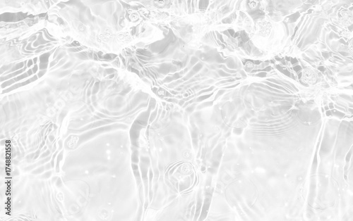 White water with ripples on the surface. Defocus blurred transparent white colored clear calm water surface texture with splashes and bubbles. Water waves with shining pattern texture background.