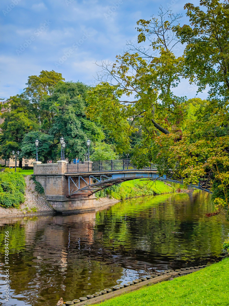 Obraz premium Bastejkalna Park and Daugava canal in center of Riga. Park with bridges in Riga old town. Touristic place