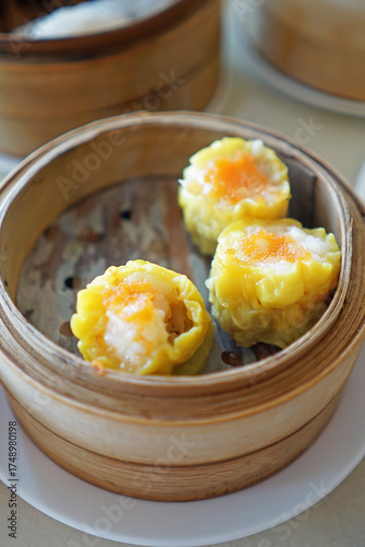 Close up minced pork and shrimp Shumai Dim Sum, Steamed Chinese food served in small wooden basket container