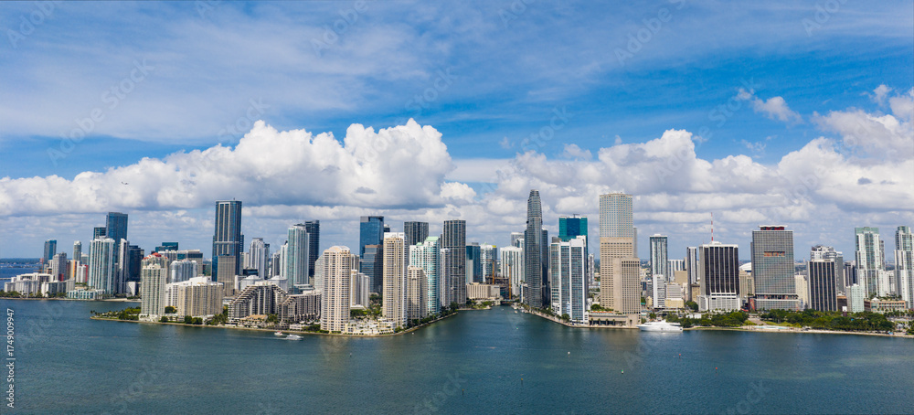 Fototapeta premium Aerial panorama of Brickell in Miami. Downtown Miami skyline on a sunny day. Scenic view of Miami Beach and Brickell. Miamis Skyscrapers. Brickell famous landmarks. Miami downtown landscape.