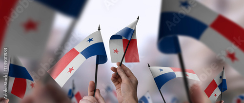 Panama flags in their hands on a blurred urban background