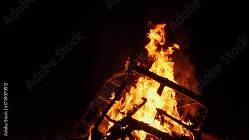 Vibrant Blaze of Campfire Flames at Night in Rural Setting