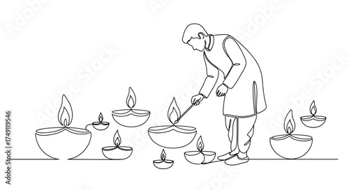 Traditional indian man lighting numerous decorative clay oil lamps for a festive celebration or religious ceremony