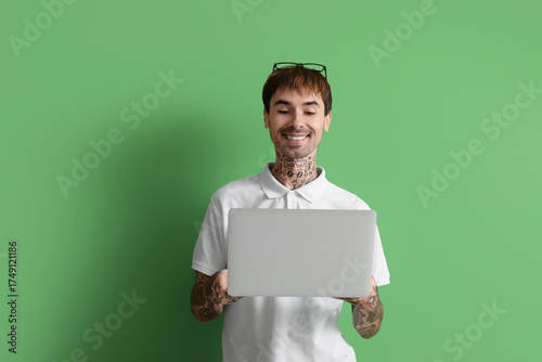 Happy young man with modern...
