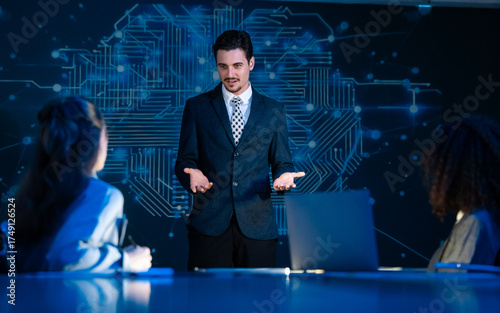 Businessman leading a presentation on artificial intelligence, machine learning, and neuroscience to his female colleagues.
